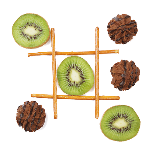 Tic-tac-toe board made with pretzel sticks, with kiwi slices and chocolate cookies as game pieces.